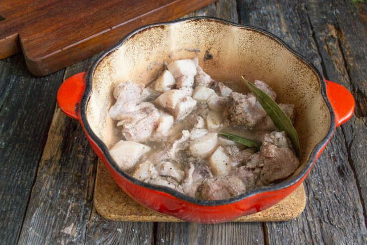 Simmering the Pork Until Tender Pork simmering in a covered pot on the stove.