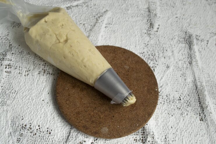 Using a piping bag to create beautifully shaped cookies. A plastic bag with a cut corner works too! Filling a piping bag fitted with a star tip with the chilled cookie dough.