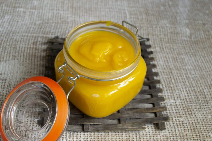 The finished pumpkin, zucchini, and apple purée, perfect for canning or serving. A jar of freshly made creamy pumpkin purée with zucchini and apples.