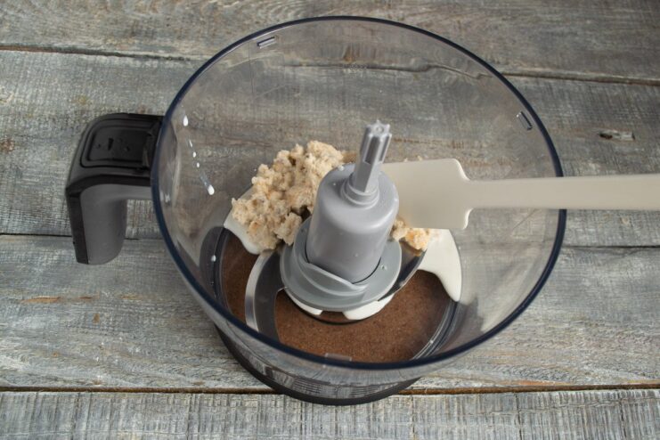 Soaked Bread in Blender - The Secret to Juicy Kotlety Soaked white bread crumb being placed in a blender bowl.