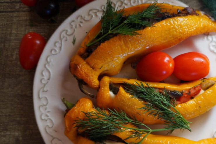 A baking sheet with golden-brown baked stuffed peppers fresh from the oven.