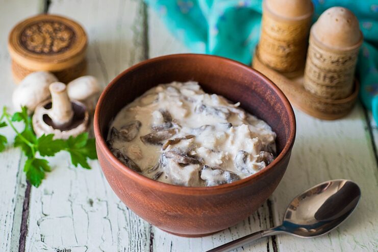 Ready in 10 minutes - The finished chicken and mushroom gravy is rich and aromatic. A close-up shot of the finished chicken and mushroom gravy in a white bowl.