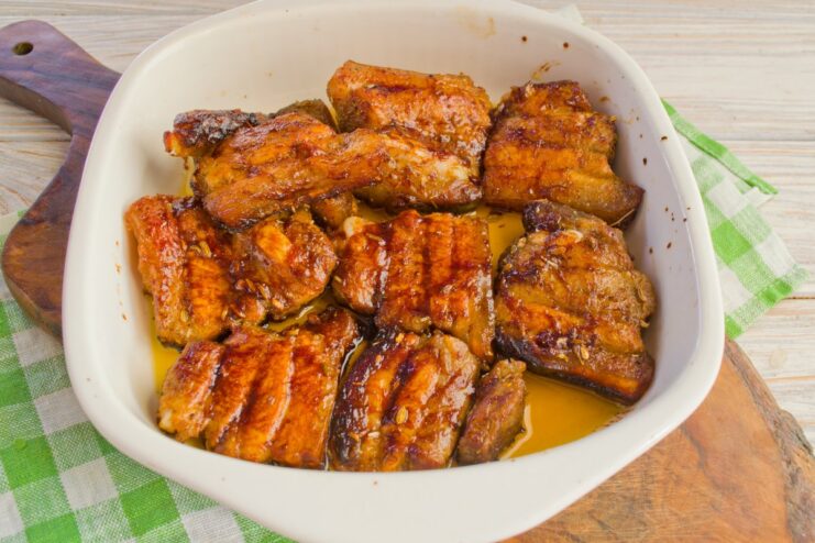 A few minutes under the broiler gives the pork a perfect crispy finish. Golden-brown, crispy pork slices in a baking dish after being broiled.