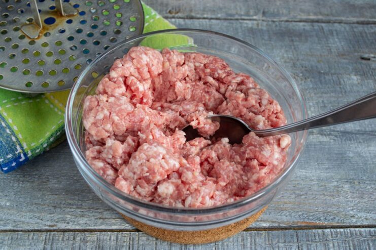 Preparing the Minced Meat Base for Tefteli Chilled minced meat in a white bowl, the first step for making tefteli.