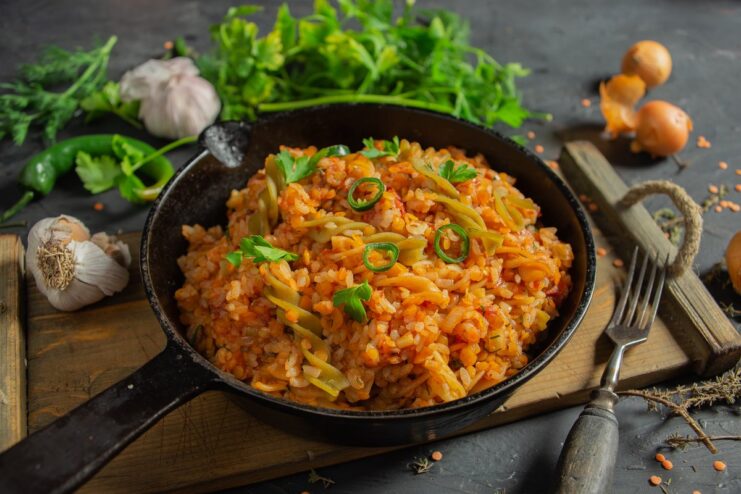A bowl of freshly made Egyptian Koshari, a mix of rice, lentils, and pasta in tomato sauce.