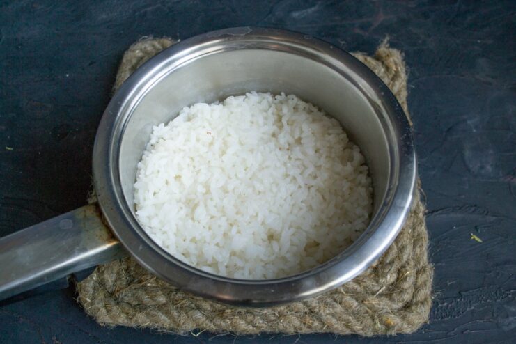 Perfectly fluffy rice is the base for Koshari A pot with cooked rice, wrapped in a towel to steam.
