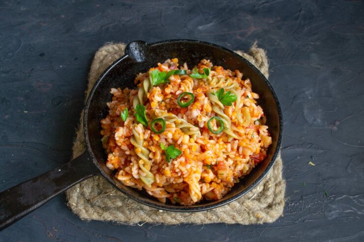 Serve your homemade Koshari hot and enjoy! A serving of Egyptian Koshari in a white bowl, ready to be eaten.