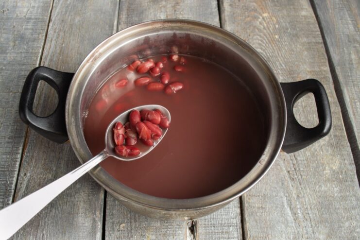 Preparing Red Beans for the Stew: Soaking and Boiling Cooked red beans in a pot, ready to be added to the spicy stew.