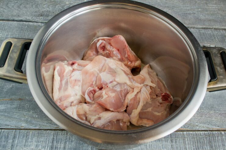 Step 1: Preparing the Chicken for the Broth Raw chicken pieces in a large pot, ready for making broth.