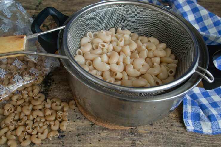 Spelt horn pasta being boiled in a pot of water.