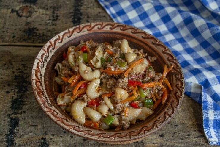 A serving of Spelt Horn Pasta with Beef in a white bowl, ready to eat.
