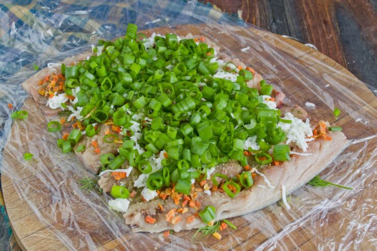 Adding Freshness with a Layer of Chopped Green Onions Finely chopped green onions sprinkled over the layer of grated egg white.