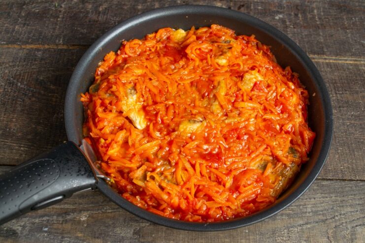 Letting the fish rest in the marinade to absorb all the flavors Cooked fish resting in the carrot and onion marinade in a skillet off the heat.