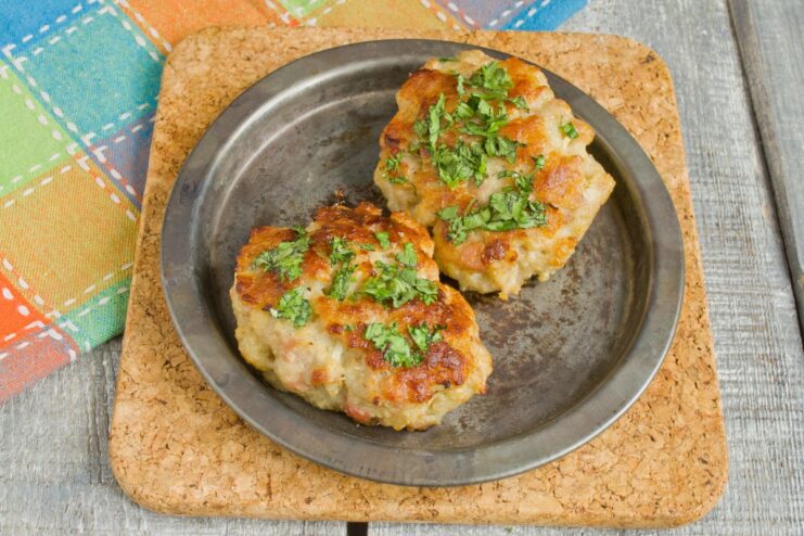Delicious Homemade Pork Patties Ready to Serve A plate of freshly cooked, juicy pork patties, garnished with herbs.
