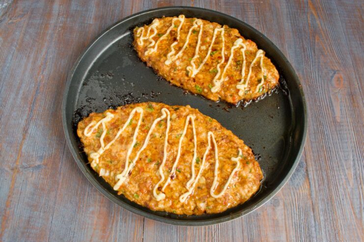 Baking the Chicken Schnitzels Until Golden and Cooked Through The pan with two chicken schnitzels baking inside a hot oven.