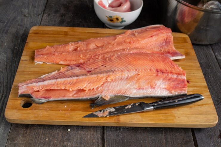 Step-by-Step: Filleting a Pink Salmon A sharp knife separating a pink salmon fillet from its backbone.