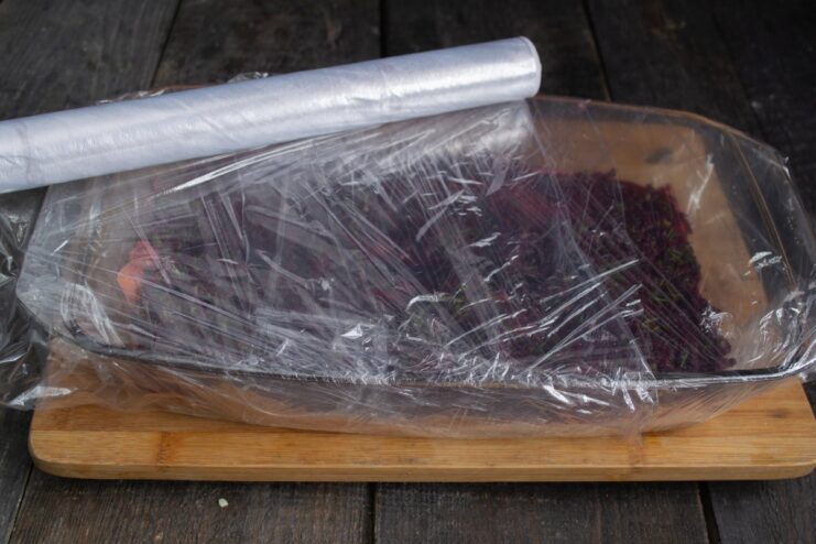 Curing the Salmon in the Refrigerator The salmon fillet, covered in cure and wrapped in plastic, ready for refrigeration.
