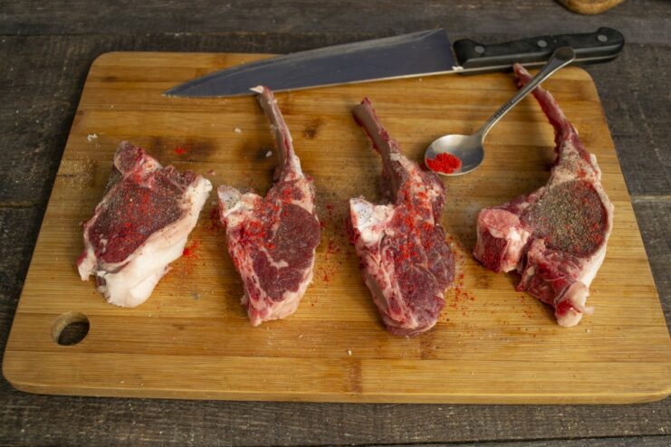 Generously seasoning the lamb chops for maximum flavor Seasoning lamb chops with salt, pepper, and paprika.