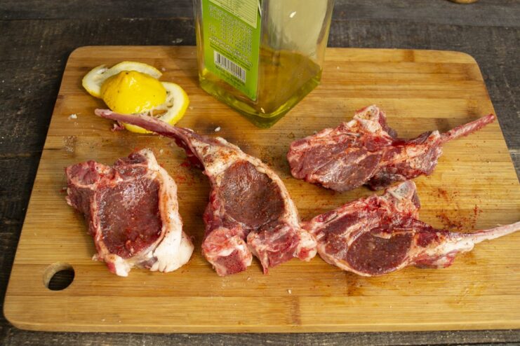 Coating the lamb chops with oil to prevent sticking Brushing marinated lamb chops with oil before cooking.