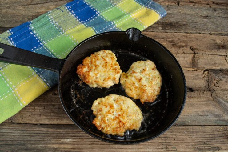 Pan-Frying Chicken Cutlets to a Perfect Golden Brown Chicken cutlets sizzling in a hot pan, being fried to a perfect golden brown color.