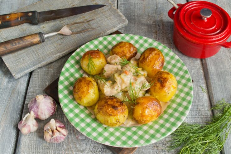 Enjoy Your Delicious Homemade Pork and Zucchini Stew The finished pork and zucchini stew served on a plate with fried potatoes.