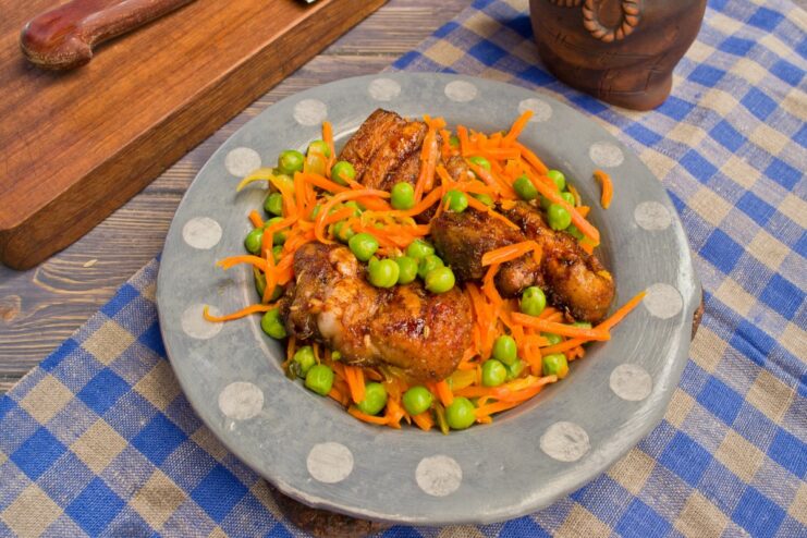 Finished Dish: Hearty Pork and Vegetable Bake The finished oven-baked pork with vegetables served in a white bowl.