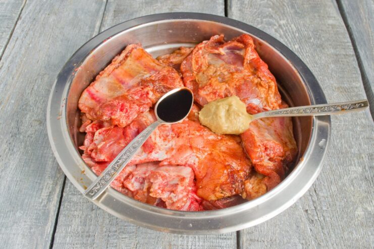 How to Marinate Pork Ribs for Maximum Flavor Pork ribs in a bowl, coated with a dark marinade of soy sauce and spices.
