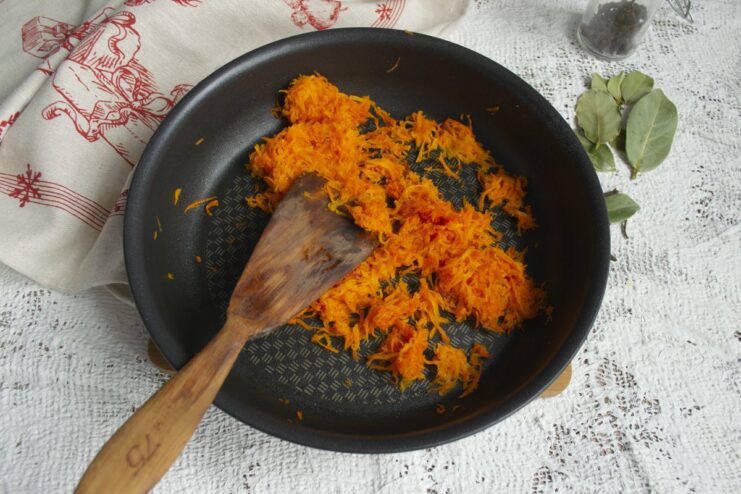 Preparing the Carrot 'Peel' for the Tangerines Sautéed grated carrots in a frying pan, creating the coating for the cheese balls.