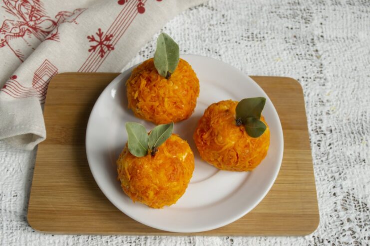 The Finished 'Mandarinki' Appetizer, Ready to Serve The finished 'Mandarinki' cheese appetizers arranged on a white plate, looking like real tangerines.