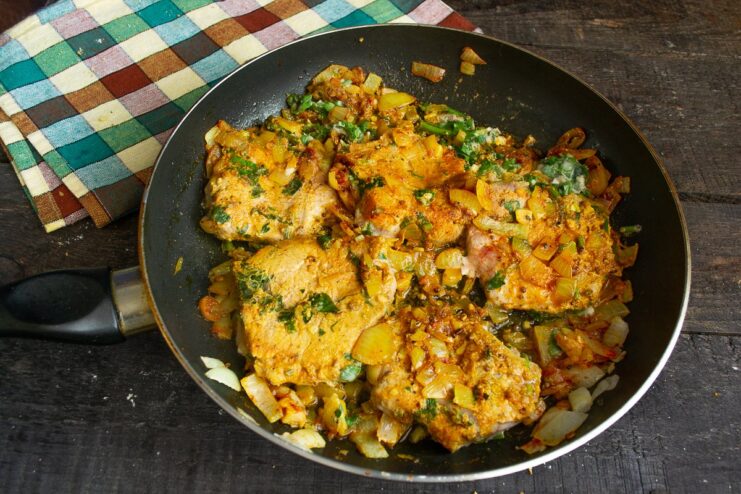 Cooking the meat on both sides ensures it's perfectly cooked through. Pieces of meat cooking in a pan with a creamy sauce.