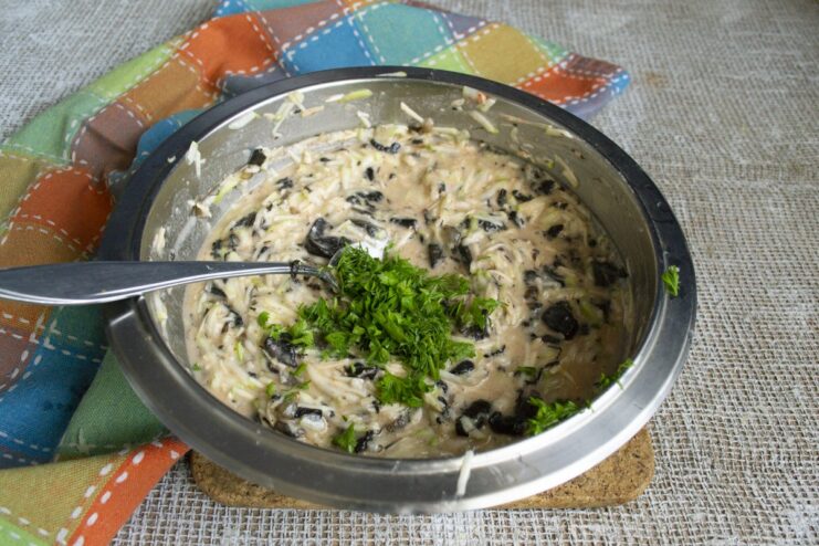 Adding fresh chopped parsley for a burst of freshness and color. Freshly chopped parsley being added to the final zucchini fritter batter.