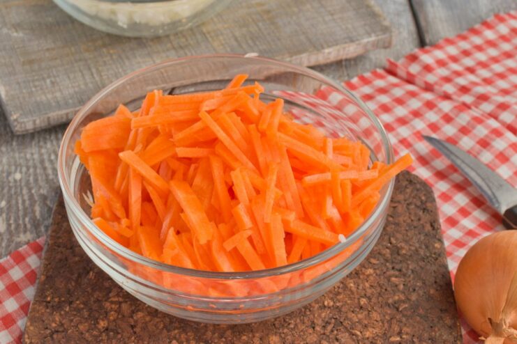 Grated Carrots for Sweetness and Color A pile of freshly grated carrots ready for cooking.
