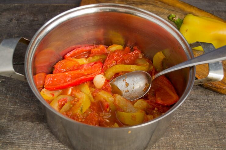 Simmering the Vegetables to Perfection in a Heavy-Bottomed Pot A pot of vegetables simmering on a stove over low heat.