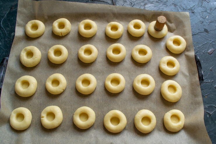 A clever trick for making perfect cookie indentations Using a wine cork to press an indentation into the center of a cookie dough ball.