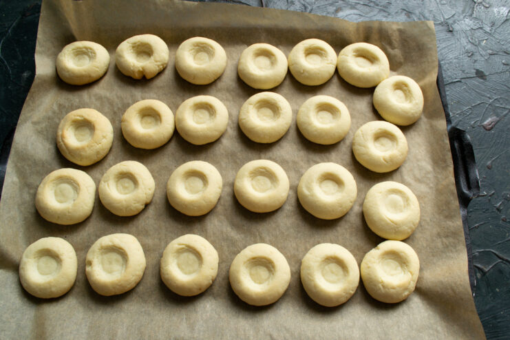 Perfectly baked golden vanilla cookies Vanilla cookies baked to a light golden brown on a baking sheet.
