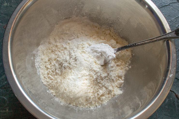 Step 1: Sifting flour for the cookie dough Sifting all-purpose flour into a glass bowl for the vanilla cookie recipe.