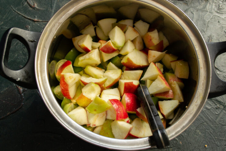 Step 3: Dicing apples to match the size of the physalis pieces. A bowl containing diced apples and quartered physalis, ready for cooking.
