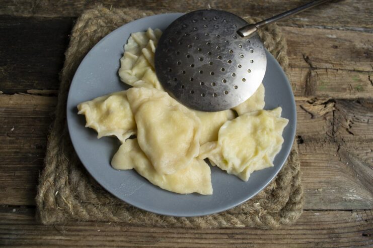 Cooking the vareniki to perfection in a pot of boiling water. Vareniki being cooked in a large pot of boiling water.