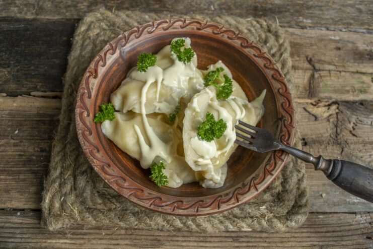 Ready to serve! Hot and delicious vareniki with potatoes. A plate of freshly cooked vareniki with potatoes, ready to be served.