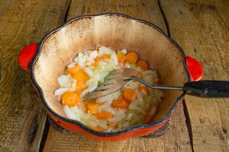 Step 3: Sautéing carrots with the softened onions. Sliced carrots added to the pot with sautéed onions.
