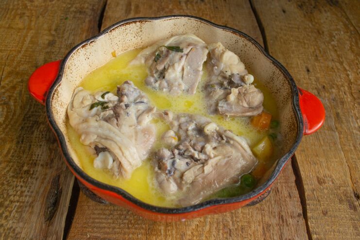 Step 7: Pouring in the milk and flour mixture to thicken the sauce. A milk and flour mixture being poured into the pot to create a creamy sauce.