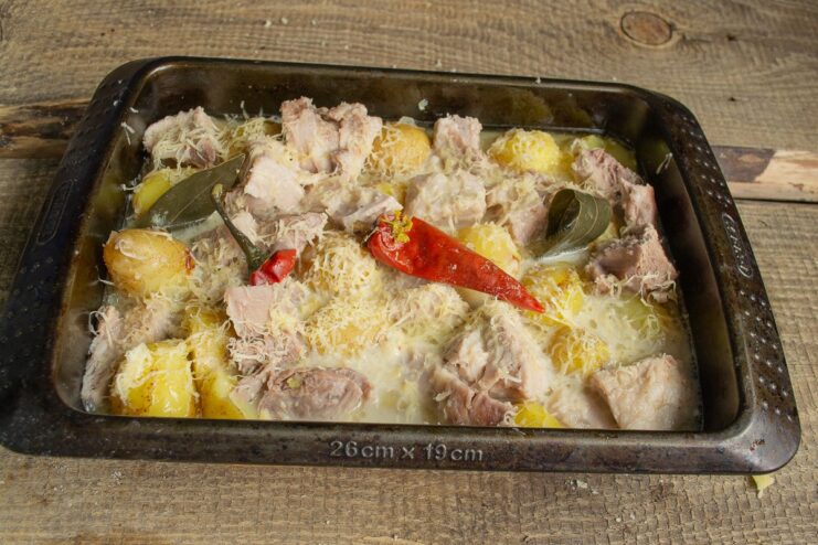 Final touches before baking to perfection The assembled casserole with cheese and chili on top, ready for the oven.