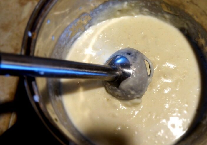 How to cook the perfect creamy Béchamel sauce Creamy white Béchamel sauce being stirred with a whisk in a saucepan on the stove.