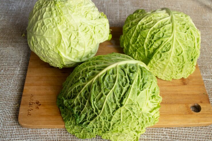 How to properly blanch savoy cabbage leaves for cabbage rolls A savoy cabbage leaf being blanched in a pot of boiling water.