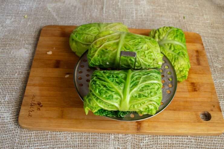 Steaming the vegetarian golubtsy to perfection Assembled vegetarian cabbage rolls arranged on a steamer rack, ready for cooking.