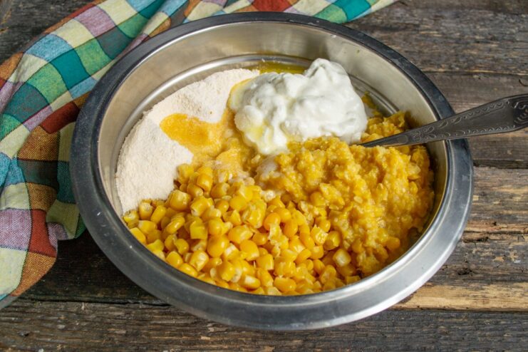 Mixing the Corn Pie Batter Ingredients A large bowl with all corn pie ingredients—kernels, puree, flour mix, and smetana—before mixing.