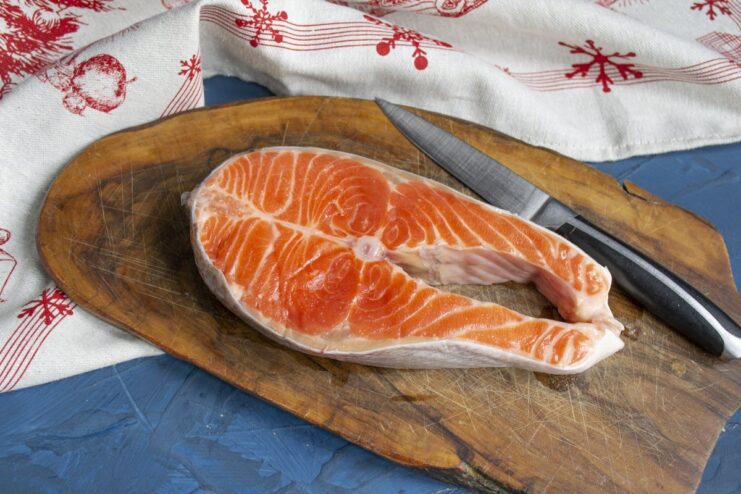 Starting with a high-quality, thick trout fillet is key to a juicy result. A thick, fresh fillet of raw trout on a cutting board.