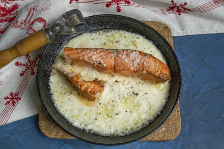 Perfectly baked trout should be moist and slightly pink in the center. A close-up of the cooked trout, showing its juicy and tender pink center.