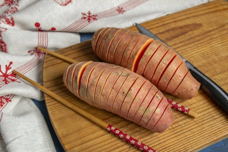 How to Slice Hasselback Sweet Potatoes Slicing a sweet potato Hasselback-style using chopsticks as a guide.
