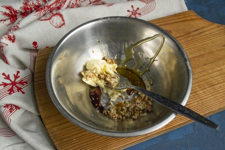 Preparing the Honey-Nut Glaze A bowl containing the mixture for the glaze: butter, honey, walnuts, and soy sauce.